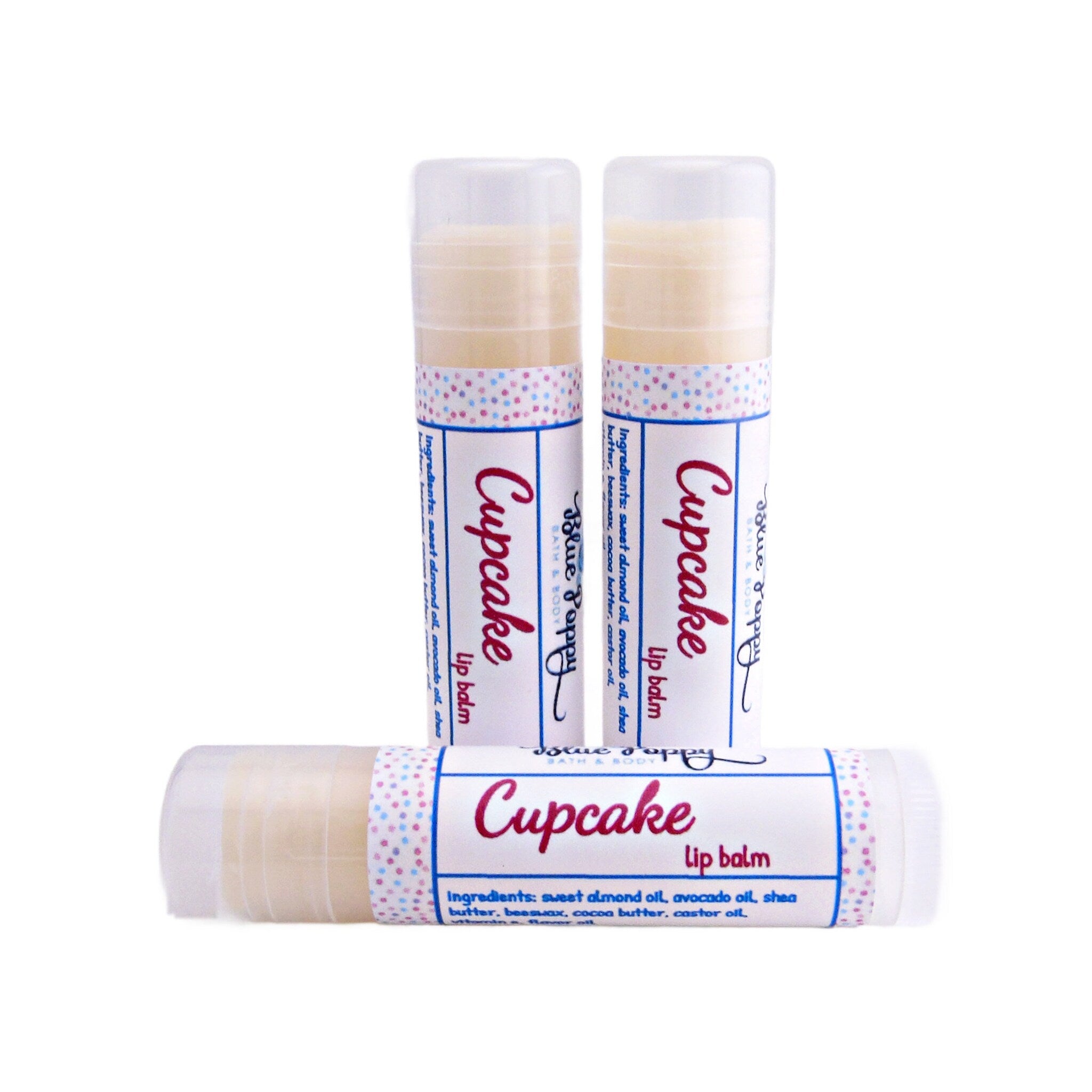 Lip balm tubes with white, pink, and blue polka dot pattern and Blue Poppy brand name visible
