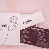 Ear seeds packaging with white box, black text, and Seeded brand name
