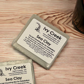 Facial Cleanser bar, gray rectangular bar, "Ivy Creek" label, on wood surface