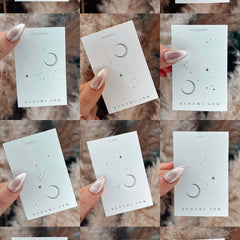 Close-up of 12 sleek skincare bottles with zodiac-themed labels, showcasing minimalist design and amber glass packaging