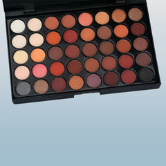 Side view of 40-color eyeshadow palette showcasing matte and shimmer shades in rectangular pans with black casing