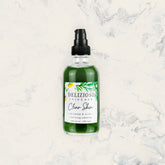 Facial cleanser bottle with green liquid, black pump, and Delizioso Skincare label on marble background