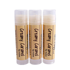 Lip balm tubes with beige labels, clear caps, and "Creamy Caramel" text by BluePoppyBath