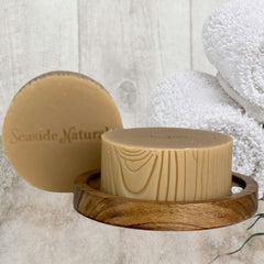 Soap bar with light brown color, wood grain pattern, and Seaside Naturals brand name shown on the soap