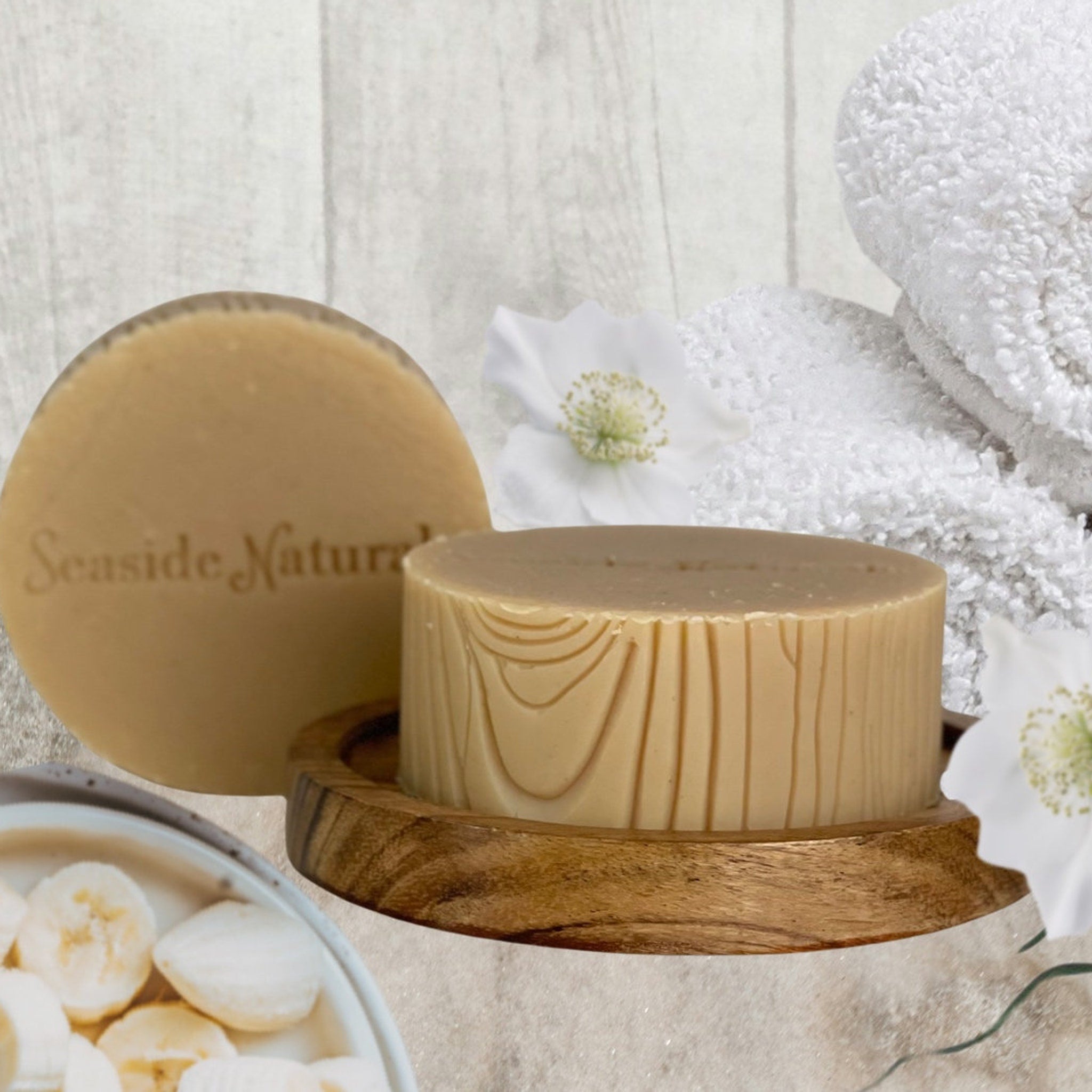 Facial cleanser bar, light brown soap, wood grain pattern, Seaside Naturals text visible