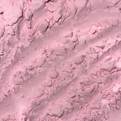 Pink powder with textured surface and subtle glitter detail, close-up view