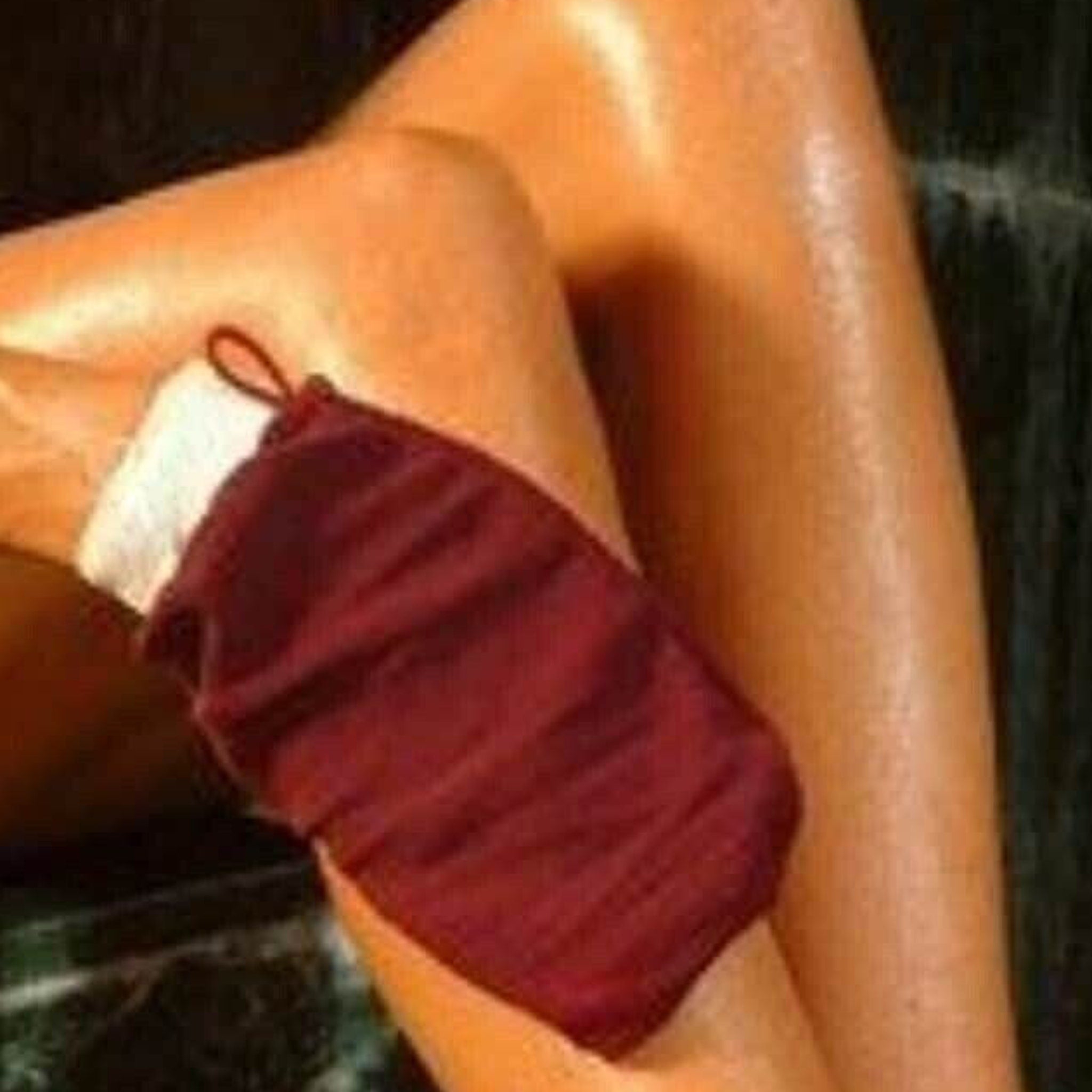 Pair of beige Moroccan hammam exfoliating gloves with textured weave for smooth skin