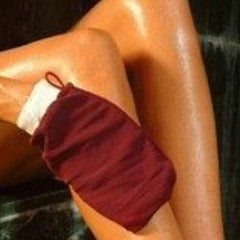 Pair of beige Moroccan hammam exfoliating gloves with textured weave for smooth skin