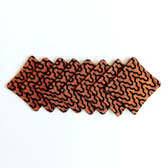 Coasters orange and black geometric pattern fabric set on white background