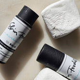 Lip balm with black tube and white label, "Skin Food" text, and white marshmallow pieces