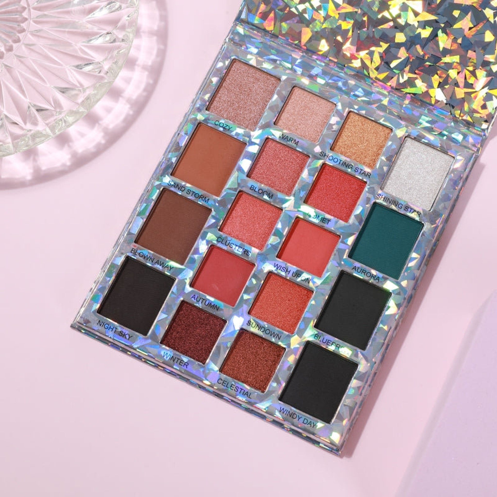 Eyeshadow palette with holographic glitter case, various colors, and Prolux brand name