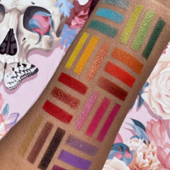 Close-up of shimmering bronze and taupe eyeshadow palette with vintage floral packaging design