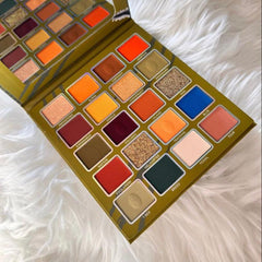 Eyeshadow palette with multiple colorful shades, Prolux brand, on a white fluffy surface