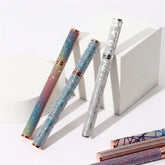 Eyeliner pens with glitter finish, various colors, and metallic accents