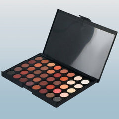 Woman applying shimmery taupe eyeshadow with a blending brush from the 40-color palette