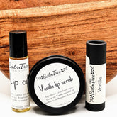 Lip balm set with black and white labels, and wooden background, BalmTree brand