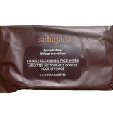 Stack of twelve all-natural hydrating face wipes in soft green packaging with gold accents, gentle cleansing formula