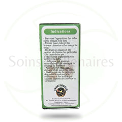 Golden jojoba oil being gently massaged into glowing skin with fingertips for deep hydration