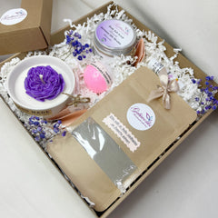 Gift box set with purple candle, pink bath bomb, and GABIWORKS branding visible