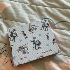 Disney Pixar Toy Story eyeshadow palette featuring colorful square pans with Woody and Buzz Lightyear designs