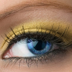 Eye makeup with gold eyeshadow, blue eye, and black eyelashes close-up