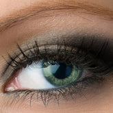 Eyeshadow makeup with black color and silver shimmer applied to eye