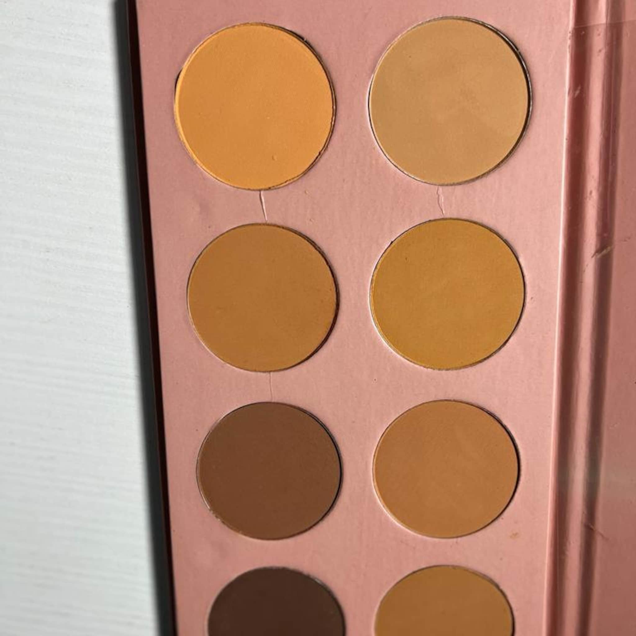 Powder palette with multiple shades of orange and brown in a pink compact