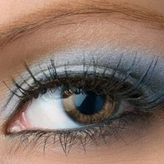 Eye with brown iris, black eyelashes, and grey eyeshadow application
