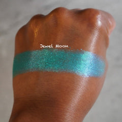 Jewel Moon eyeshadow swatch, teal shimmer, applied on skin, Jewel Moon text visible