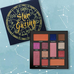 Eyeshadow palette with multiple colors, black case, and Star Gazing text, on a blue background
