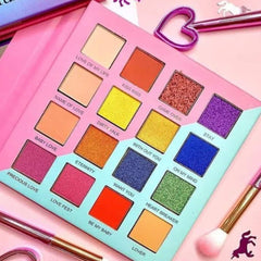 Eyeshadow palette with multiple shades in pink, orange, yellow, and blue colors, with text labels