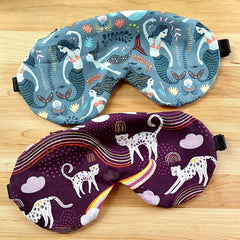 Sleep masks with mermaid and cat patterns, blue and purple fabric, black elastic band