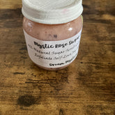 Sugar scrub jar, pink scrub, white label with Mystic text, on wood surface
