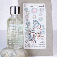 Side view of amber glass bottle with gold dropper, showcasing weightless dry oil texture against natural light