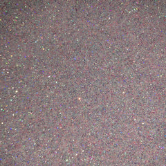 Close-up of iridescent pink fairy dust glitter eyeshadow with sparkling shimmer particles catching the light
