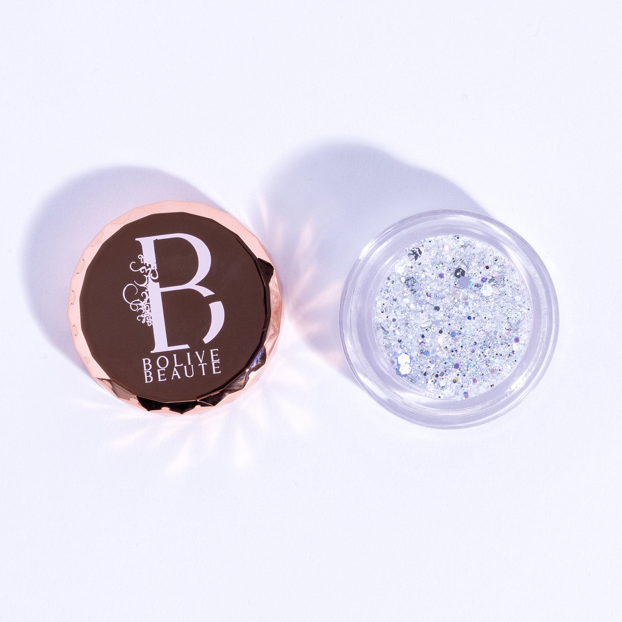 Eyeshadow glitter in white and silver with Bolive Beaute logo on lid