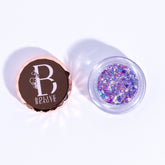 Glitter eyeshadow with iridescent purple and lavender colors in a clear jar, Bolive Beaute brand visible