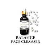 Face cleanser bottle with gold cap, dark glass, and clear crystals around it