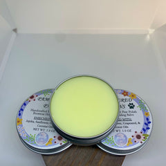 Paw salve with light green balm, silver tin, and floral label design with text