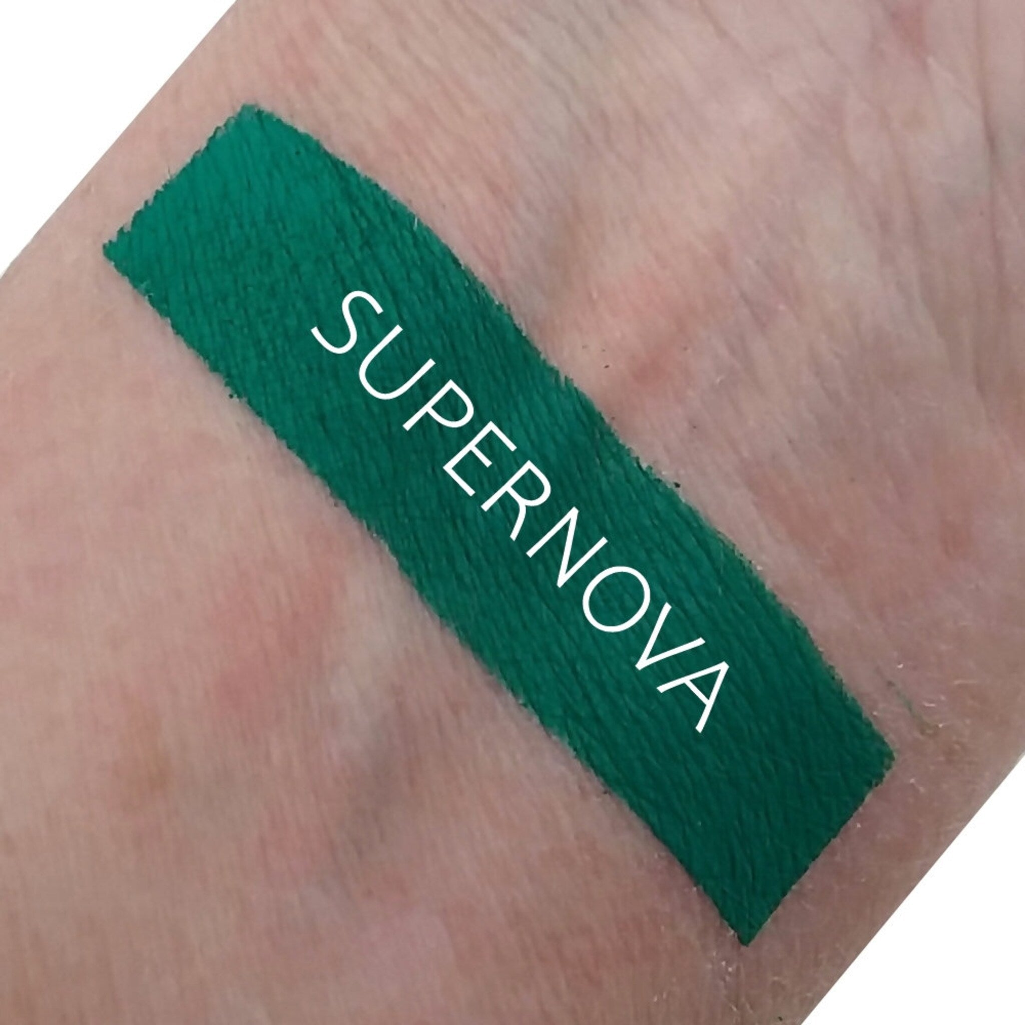 Front view of Matte Supernova Eyeshadow in a sleek black compact with color swatch showing rich pigment texture