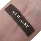 Single matte whirlwind eyeshadow pan in a neutral taupe shade with smooth, velvety texture and minimalist black packaging.