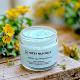 Face moisturizer jar with light blue cream, glass jar, and Nizzy Naturals label on wood surface