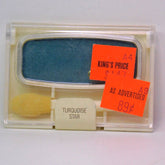 Close-up of Cover Girl Pro Vintage Eye Shadow in vibrant turquoise with satin finish, showcasing compact case