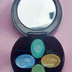 Eyeshadow palette with mirror, black plastic case, blue green and gold colors