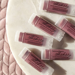 Tinted lip balm tubes, purple balm, white cap, Basswood Beauty branding