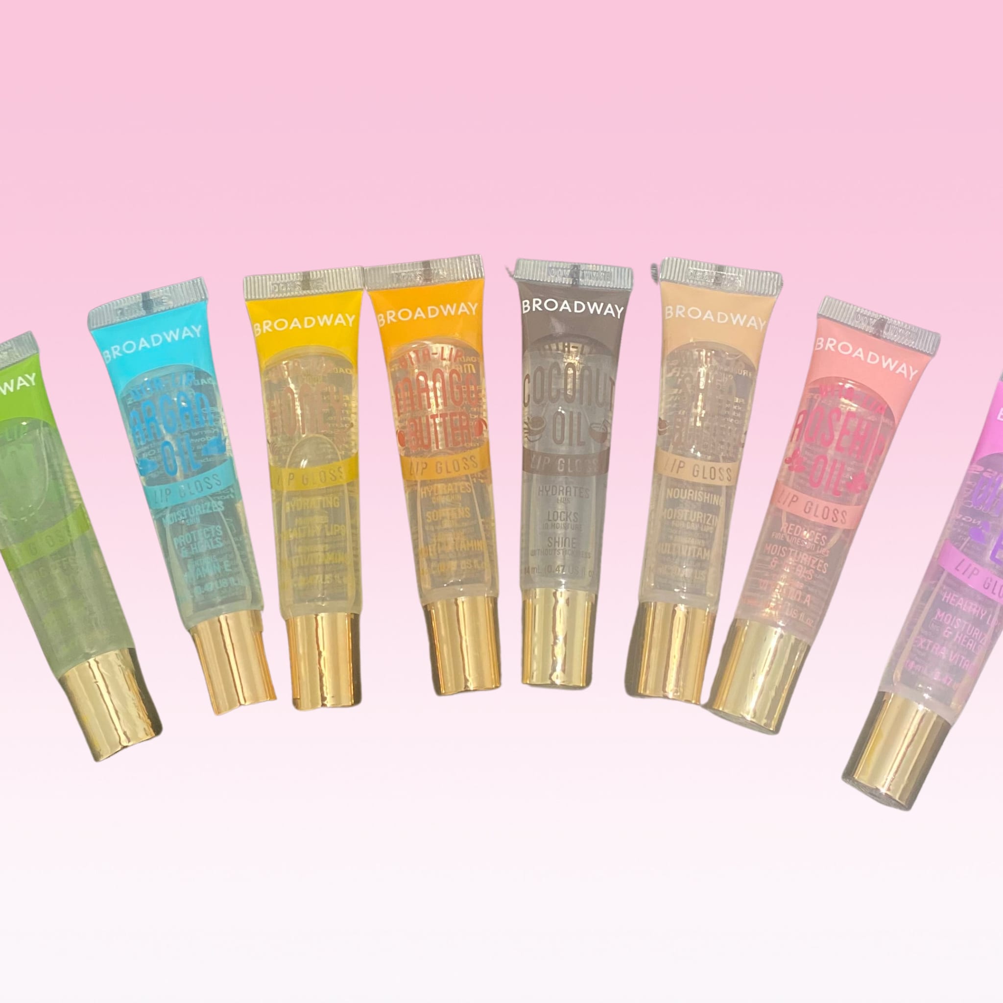 Lip gloss tubes in assorted colors with gold caps, Broadway brand visible