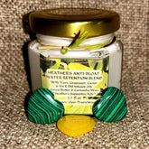 Skin care cream jar with gold lid, green and black heart-shaped stones, Heather's brand label visible
