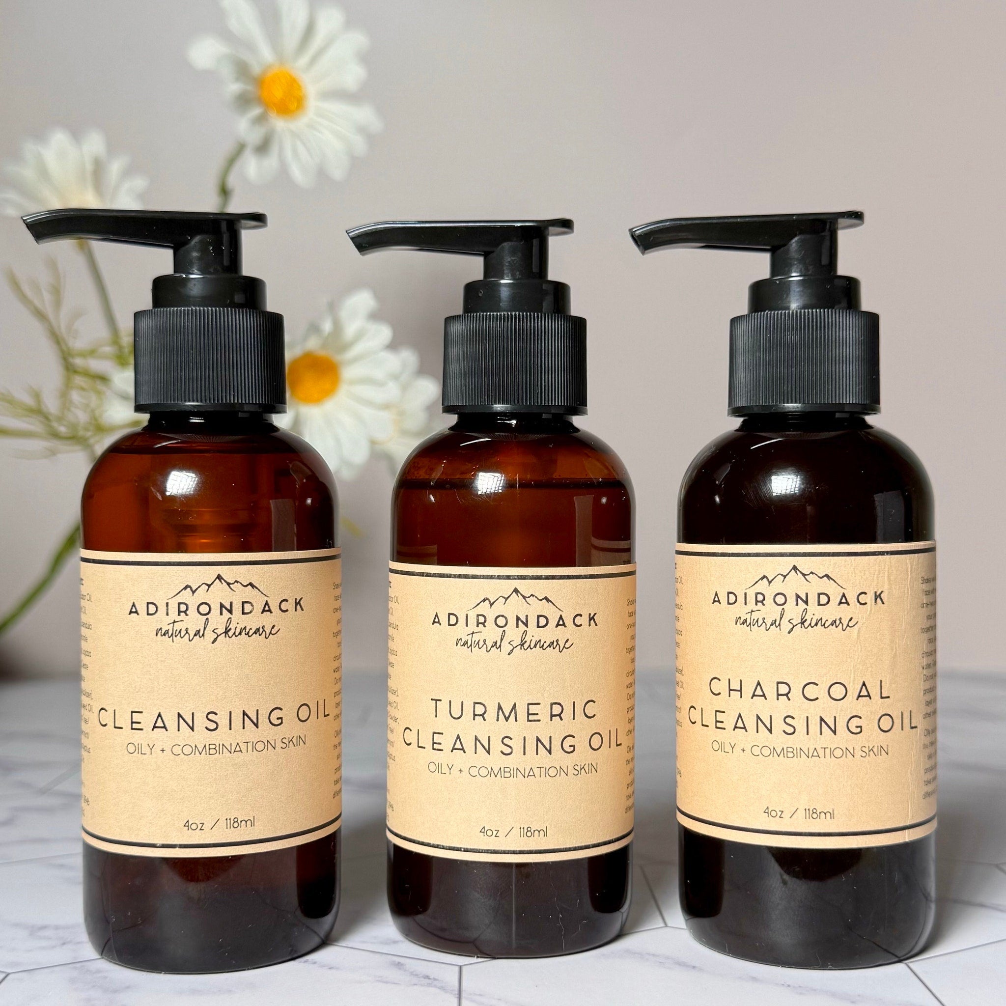 Oily skin cleanser bottles with black pump tops and brown glass, Adirondack Natural Skincare label