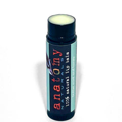 Lip balm tube with black, teal, and white label, Anatomy Naturals brand visible, for lip care