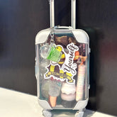 Lip gloss bundle in clear plastic suitcase with white accents and "Save the Bees" sticker